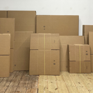Stacked cardboard boxes on wooden floor